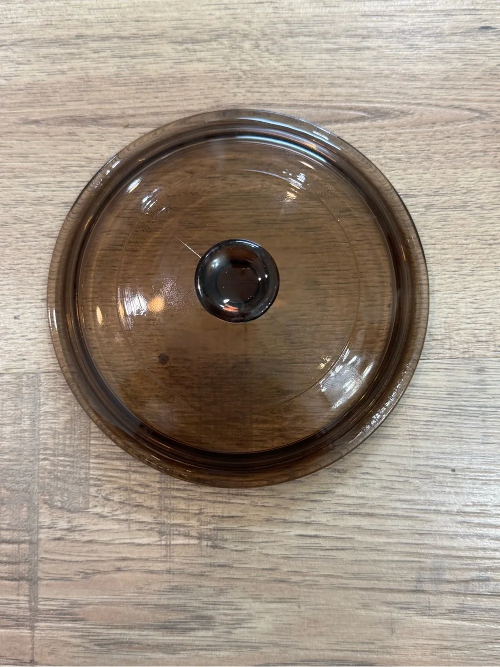 vintage Pyrex Amber lid, specifically model P-81-C.The lid is part of the Cornin